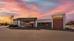 A Seasons Restaurant & Lounge with a modern design, featuring a prominent entrance and a clear view of the sky.