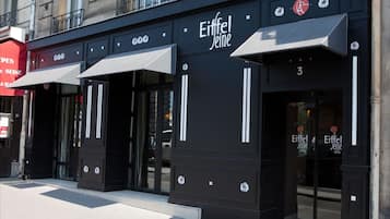 A hotel facade with the name 'Eiffel Jeine' and a number '3' on the door.