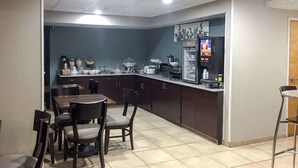 A compact kitchen with a dining area, equipped with a refrigerator, coffee machine, and various kitchen appliances. - Sleep Inn Chattanooga Hamilton Place (Chattanooga)