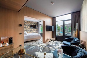 Relax in a stylish room with a large bed, flat-screen TV, and seating area.