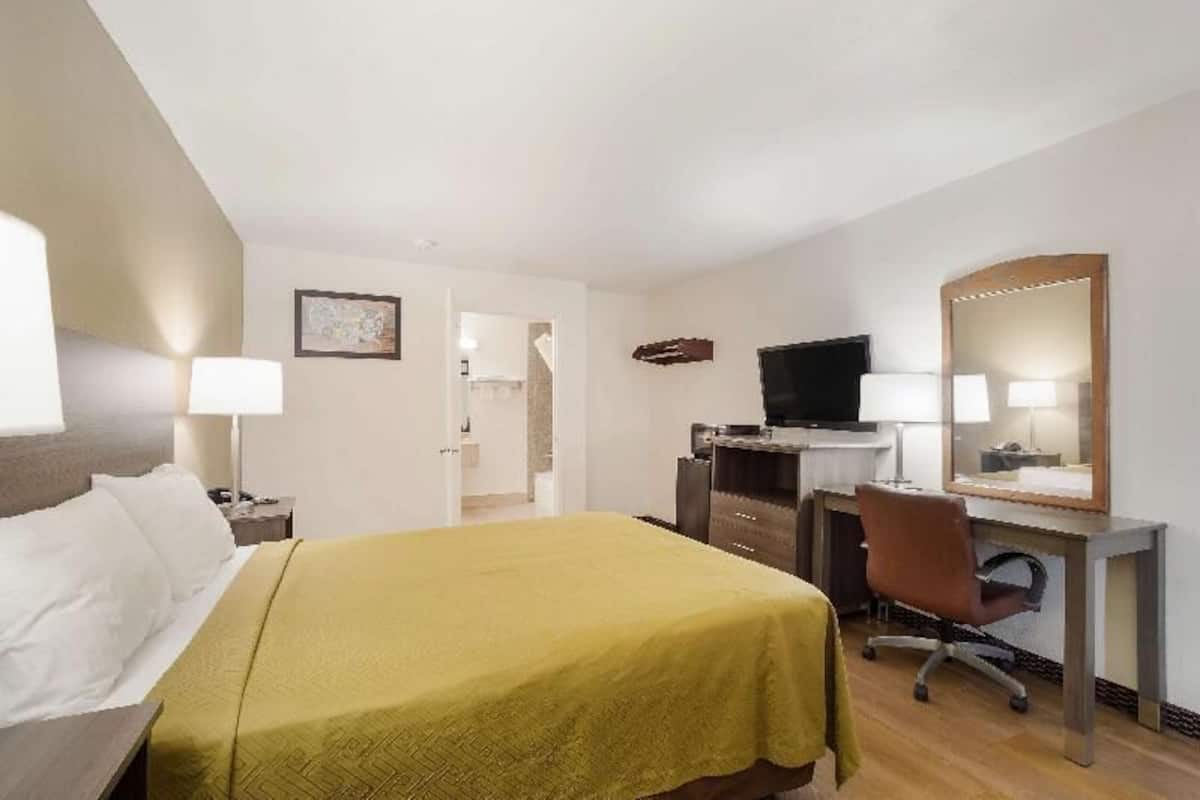 Desk, laptop workspace, blackout drapes, iron/ironing board
