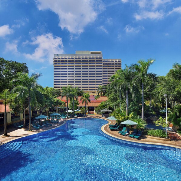 A hotel with a large swimming pool surrounded by palm trees and lounge chairs. - Artyzen Grand Lapa Macau (Macau)