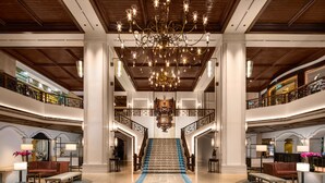 A grand lobby with a central staircase, ornate chandeliers, and a patterned carpet. - Artyzen Grand Lapa Macau (Macau)