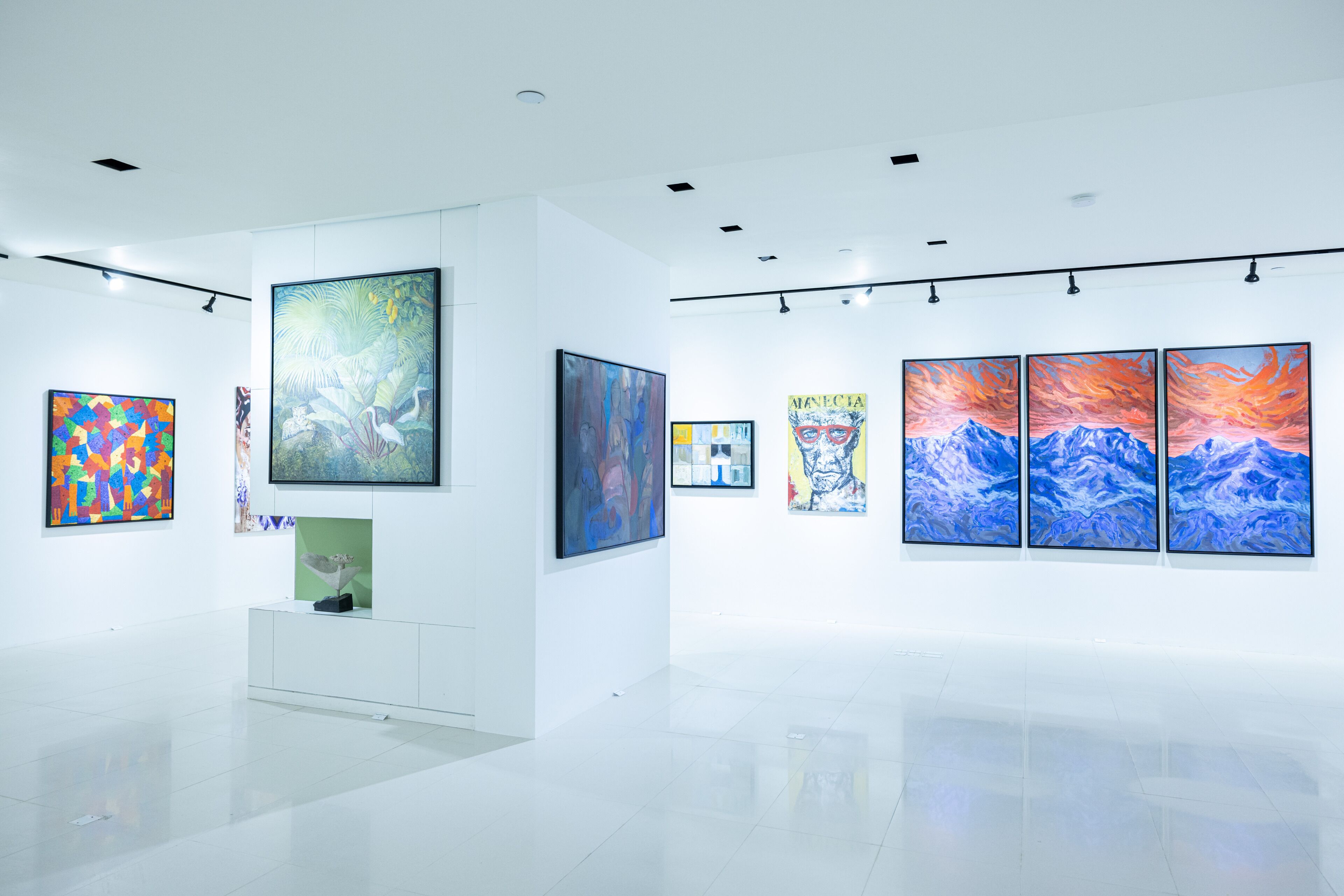 An art gallery with various paintings on display.