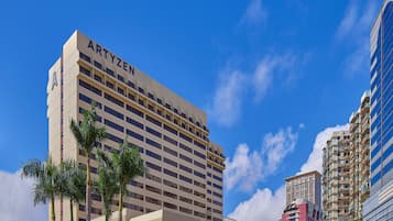 A hotel with a modern design, featuring a prominent 'ARTYZEN' sign on the facade.