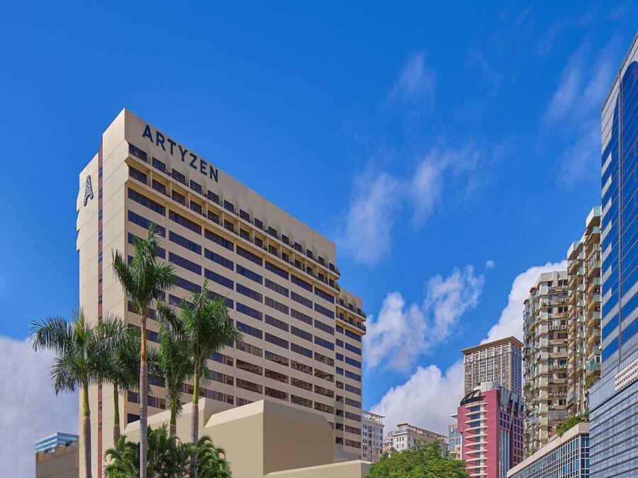 A hotel with a modern design, featuring a prominent 'ARTYZEN' sign on the facade.