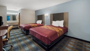 A hotel room with two beds, a desk, and a chair. - Rodeway Inn Augusta West - Fort Gordon (Augusta)