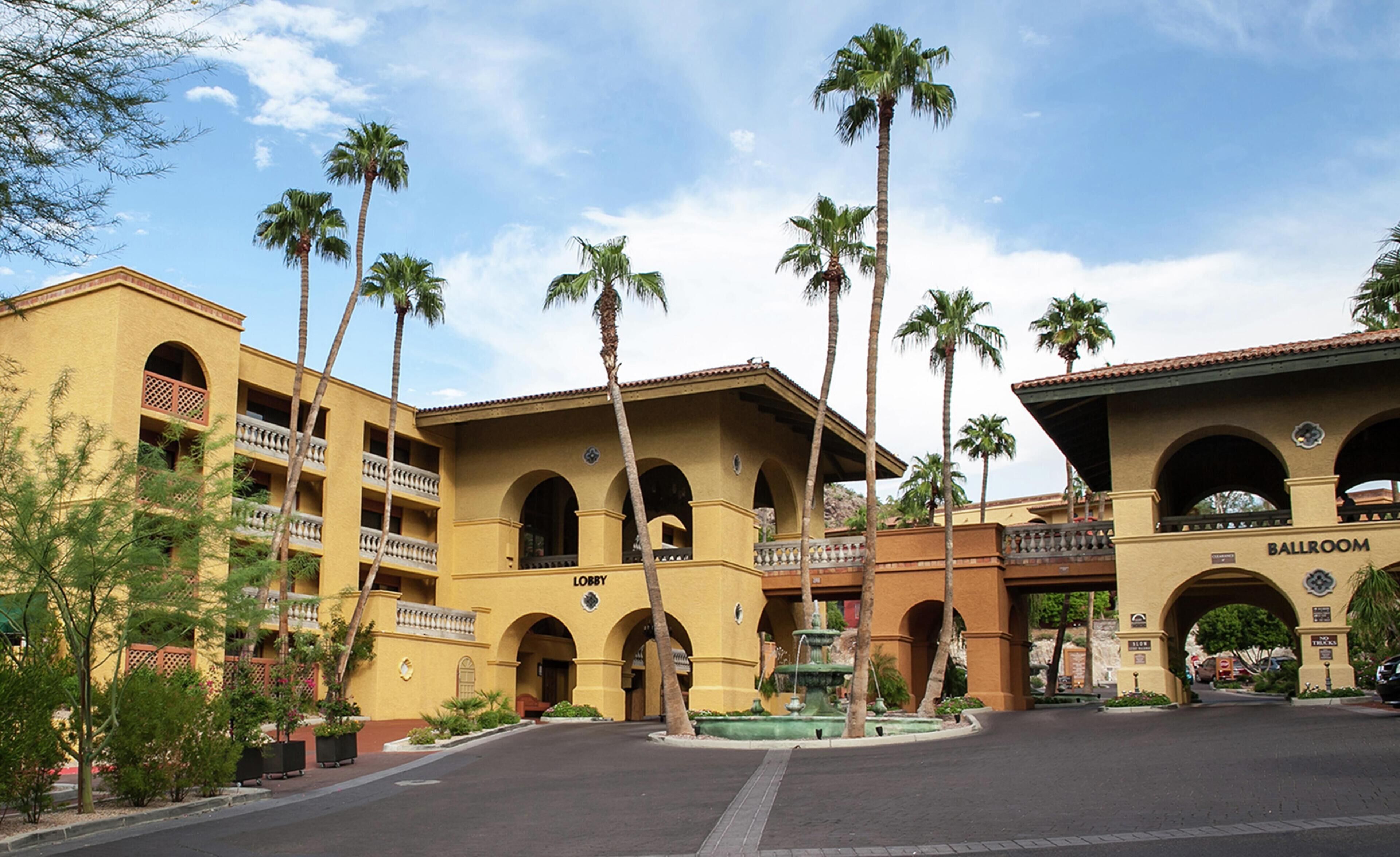 A hotel with a lobby, multiple balconies, and a visible ballroom.