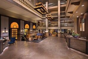 A spacious lobby with a high ceiling, multiple seating areas, and a registration desk. - Hilton Phoenix Tapatio Cliffs Resort (Phoenix)