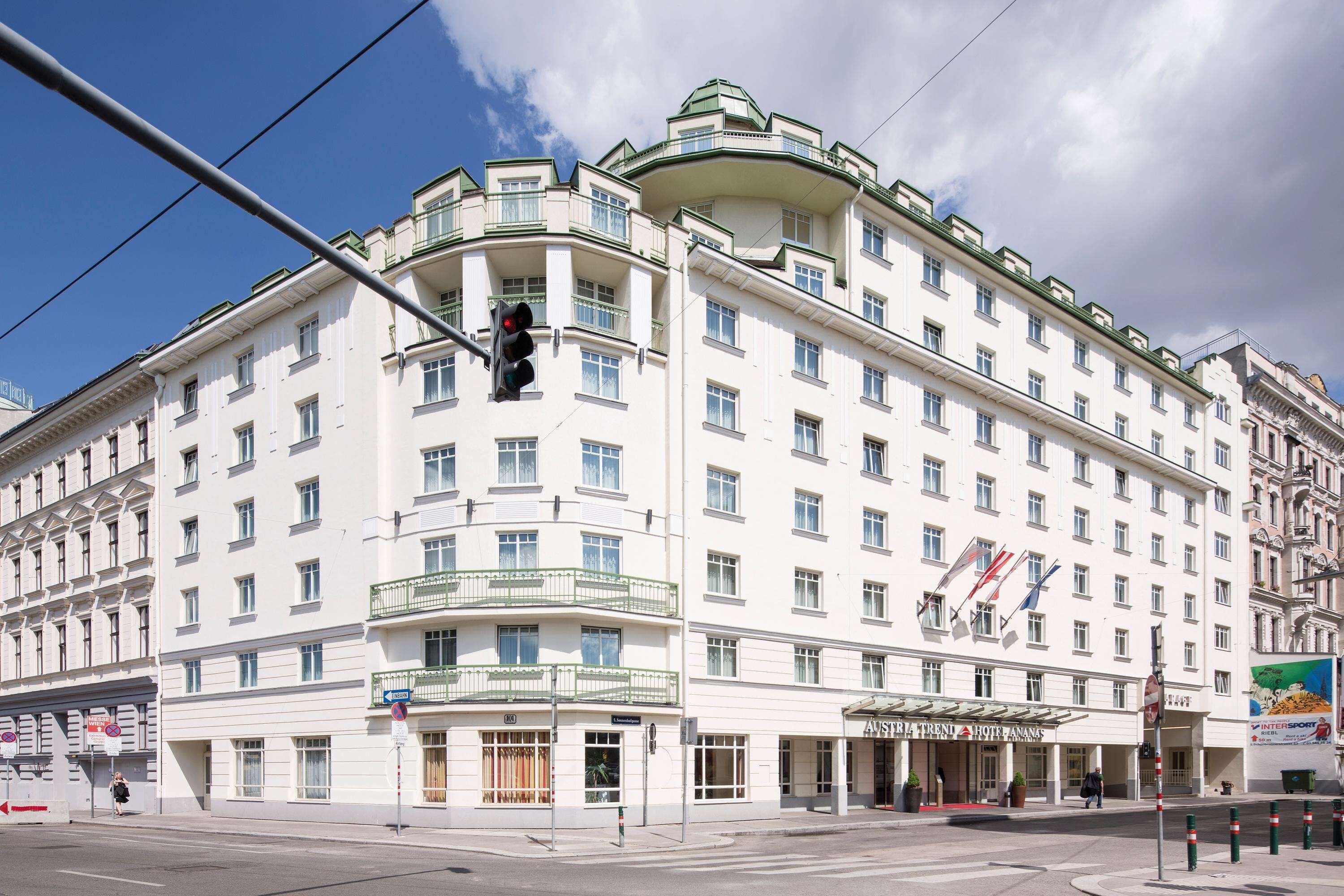 A multi-story hotel with a classic European architectural style, featuring balconies and a prominent entrance.