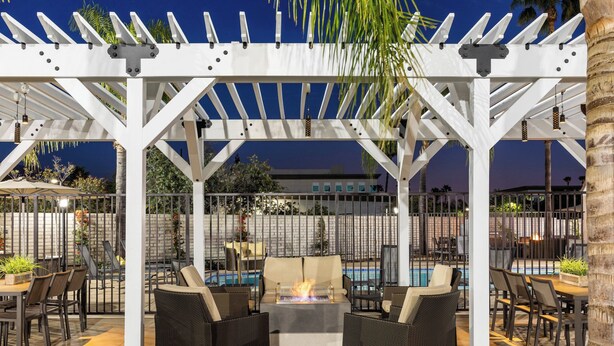 An outdoor patio area with a pergola, seating, and a pool. - Residence Inn by Marriott Pasadena Arcadia (Arcadia)