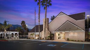 A hotel with a stone facade, a covered outdoor area, and a parking lot with handicapped spaces. - Residence Inn by Marriott Pasadena Arcadia (Arcadia)