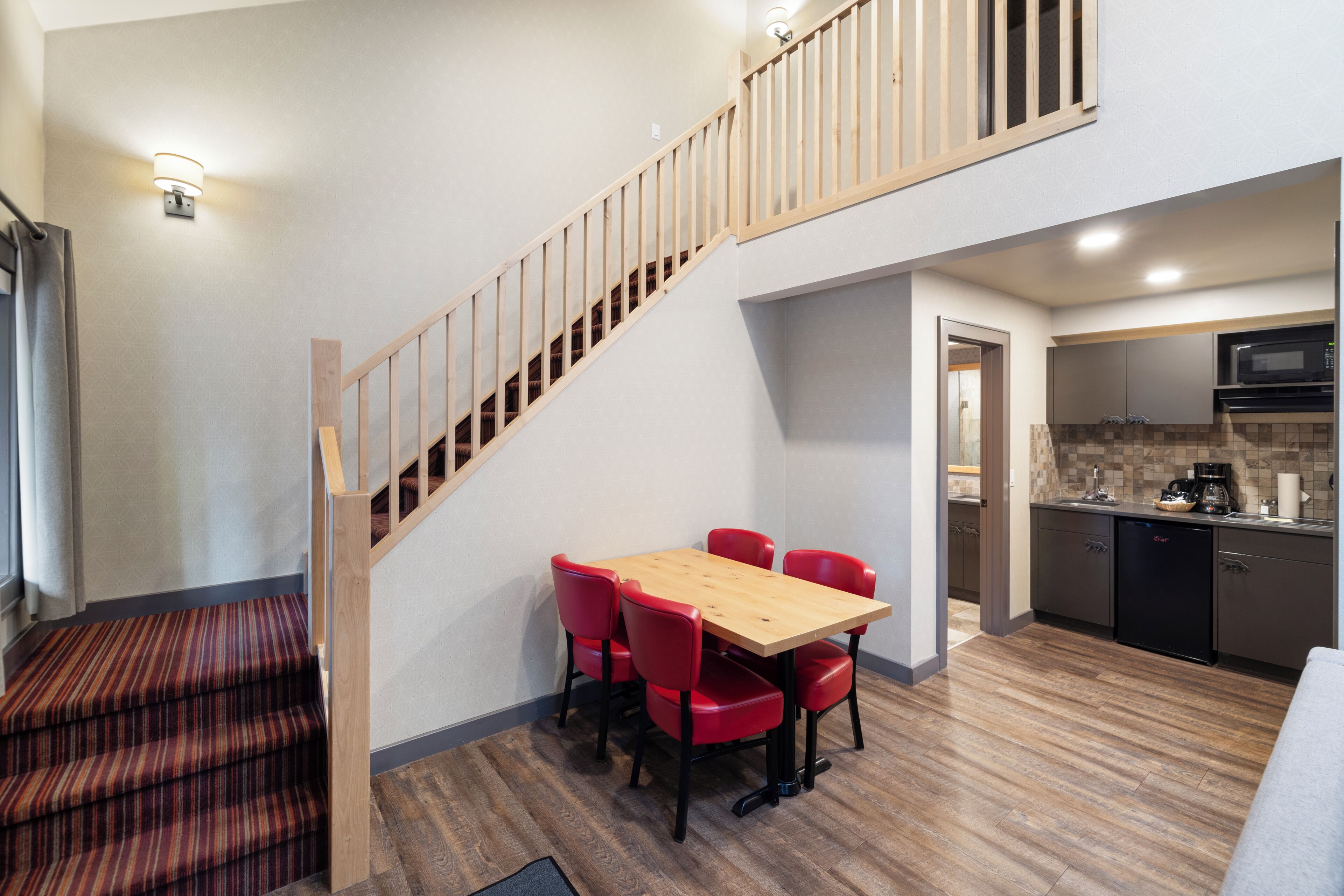 A modern kitchen with a microwave, coffee maker, and a dishwasher.
