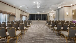 A conference room with rows of chairs, a carpeted floor, and a chandelier. - Best Western Battlefield Inn-Manassas (Manassas)