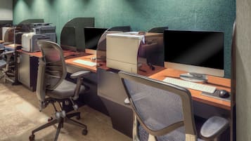 A modern office space with multiple workstations, each equipped with a computer, keyboard, and mouse.