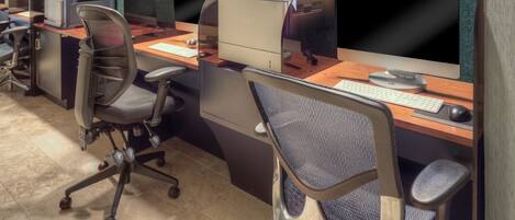 A modern office space with multiple workstations, each equipped with a computer, keyboard, and mouse.