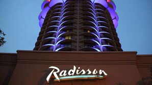 A hotel with a distinctive architectural design featuring multiple balconies and a prominent 'Radisson' sign. - Radisson Hotel Cincinnati Riverfront (Covington)