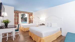 A hotel room with two beds, a desk, and a chair. - Seralago Hotel and Suites Main Gate East (Kissimmee)
