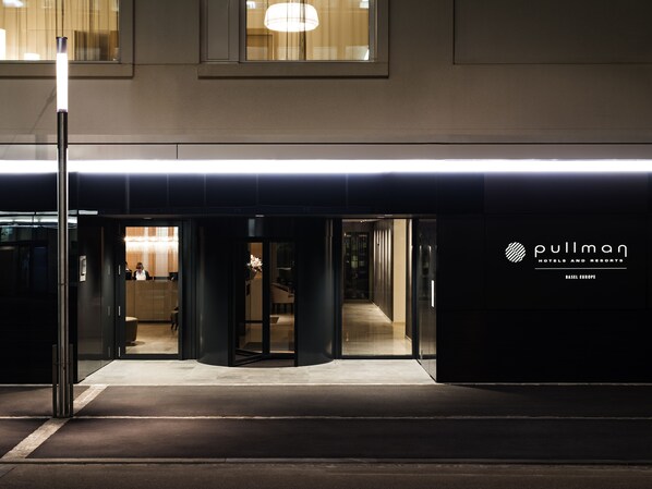 A hotel entrance with a modern design, featuring a glass door and a sign for Pullman Hotels and Resorts in Basel, Europe. - Pullman Basel Europe (Basel)