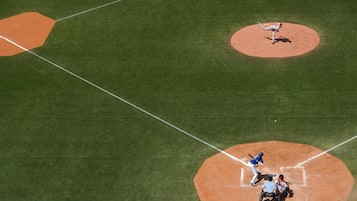 A baseball field with a pitcher, batter, catcher, and umpire.
