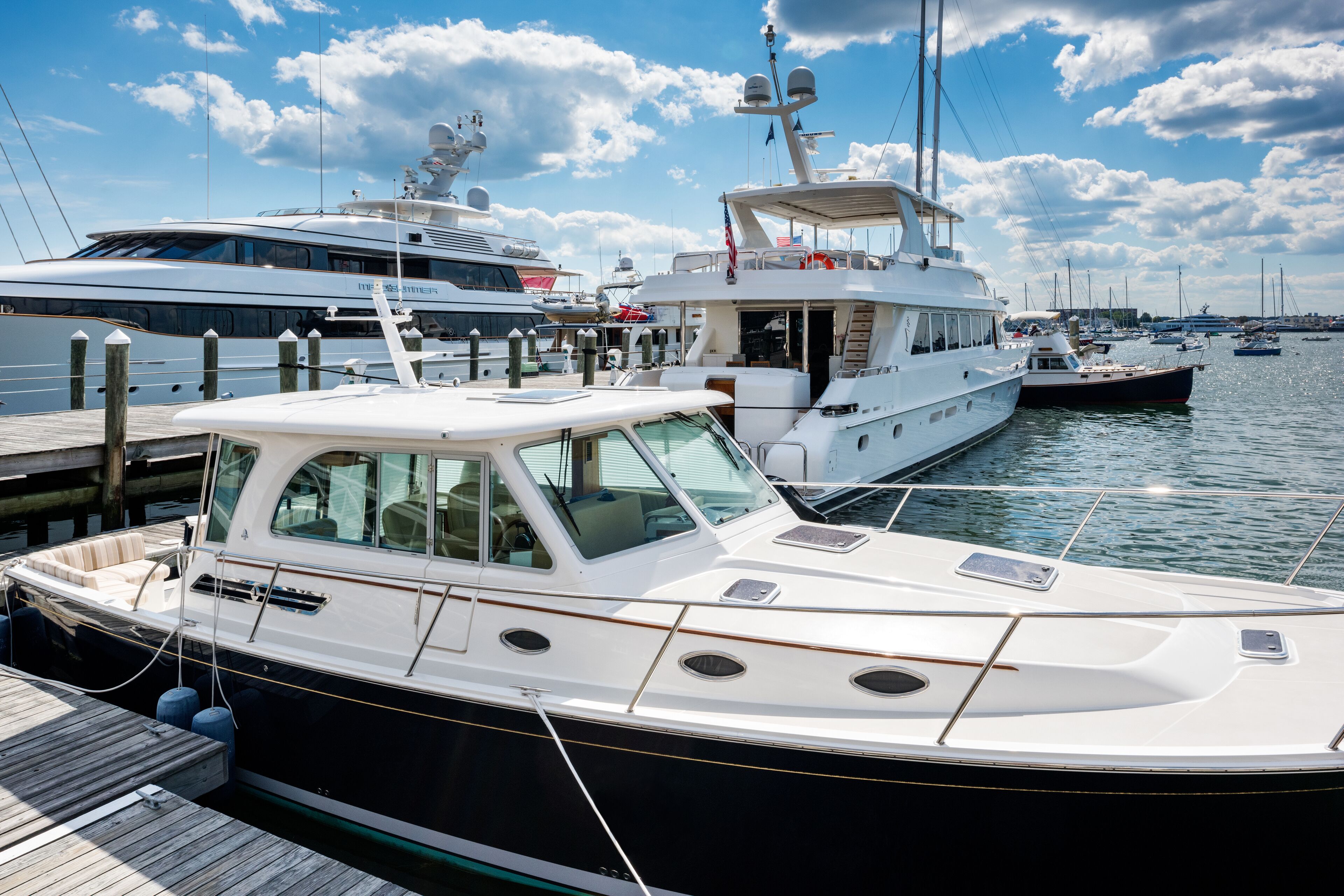 A marina with several yachts docked.