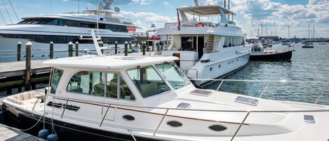 A marina with several yachts docked.