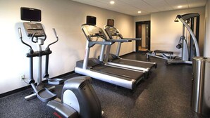 A gym with treadmills, elliptical machines, and a stationary bike. - Country Inn & Suites by Radisson, Sandusky South, OH (Milan)