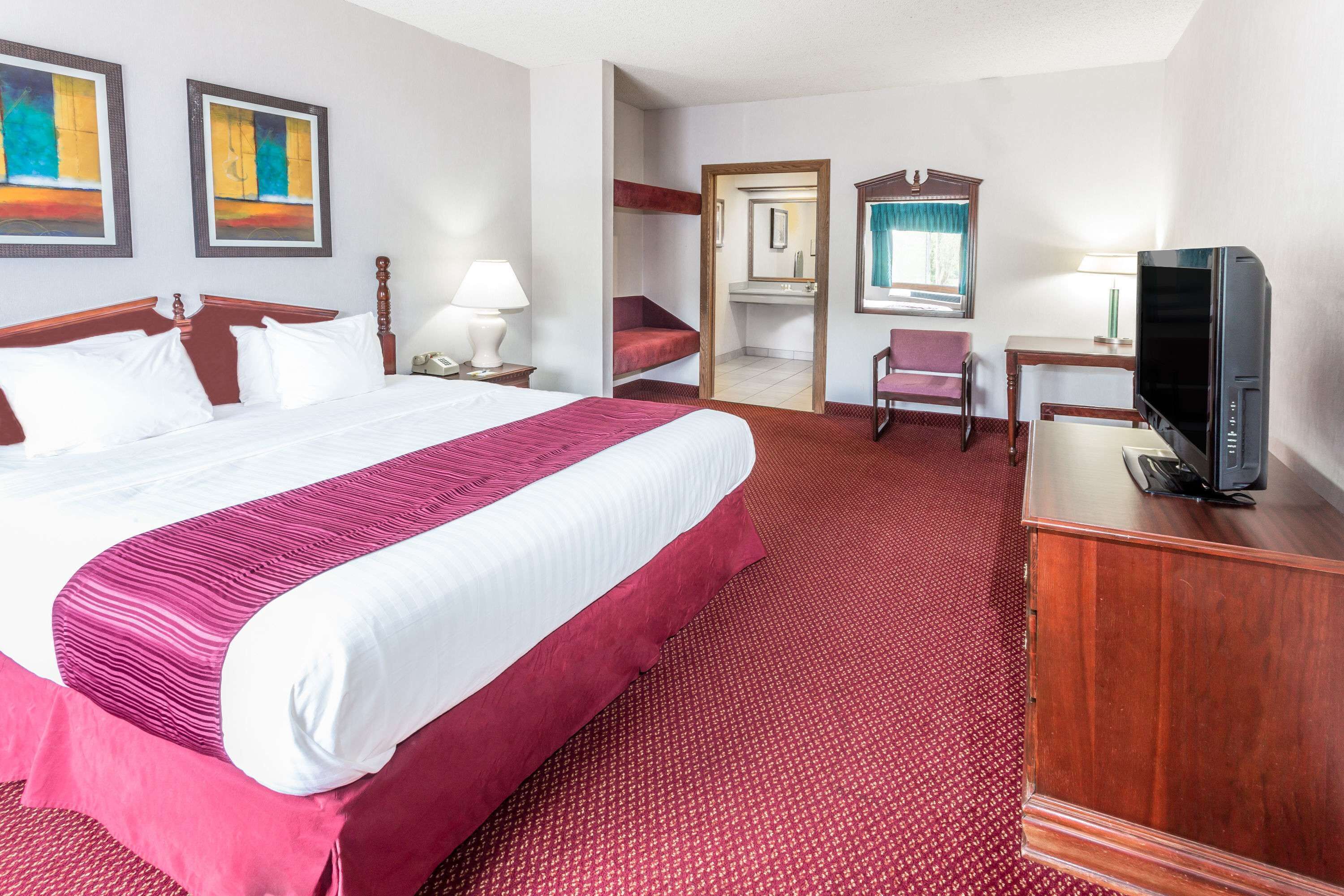 Desk, laptop workspace, blackout drapes, iron/ironing board