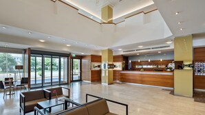 A spacious lobby with a reception desk, seating area, and large windows offering a view of the outdoors. - Austria Trend Hotel Europa Graz Hauptbahnhof (Graz)