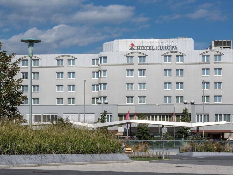 A large, modern hotel building with multiple floors and a prominent sign reading 'HOTEL EUROPA'.