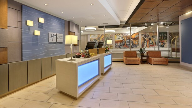 A modern reception area with a reception desk, seating, and artwork on the walls.