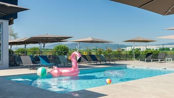 Seasonal outdoor pool, pool umbrellas, pool loungers