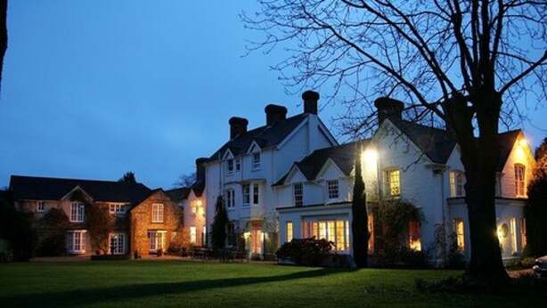 A large, multi-story house with a well-maintained lawn in front. - Esseborne Manor Hotel (Andover)
