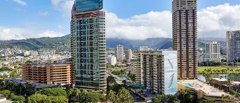 A cityscape with modern high-rise buildings, a mix of residential and commercial structures, and a clear view of the surrounding landscape.