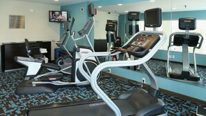 A gym with treadmills, elliptical machines, and a mirrored wall. - Quality Inn Cranberry Township (Cranberry Township)