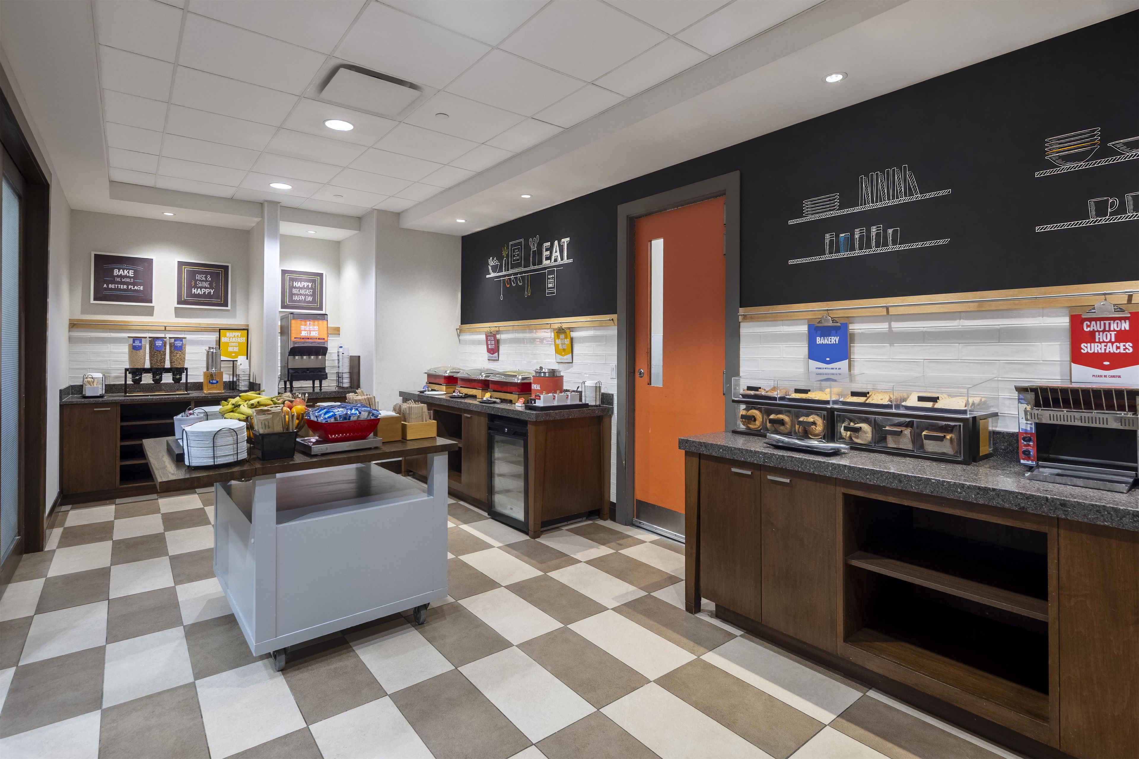 A bakery section with various baked goods displayed on shelves and a counter with a coffee machine.