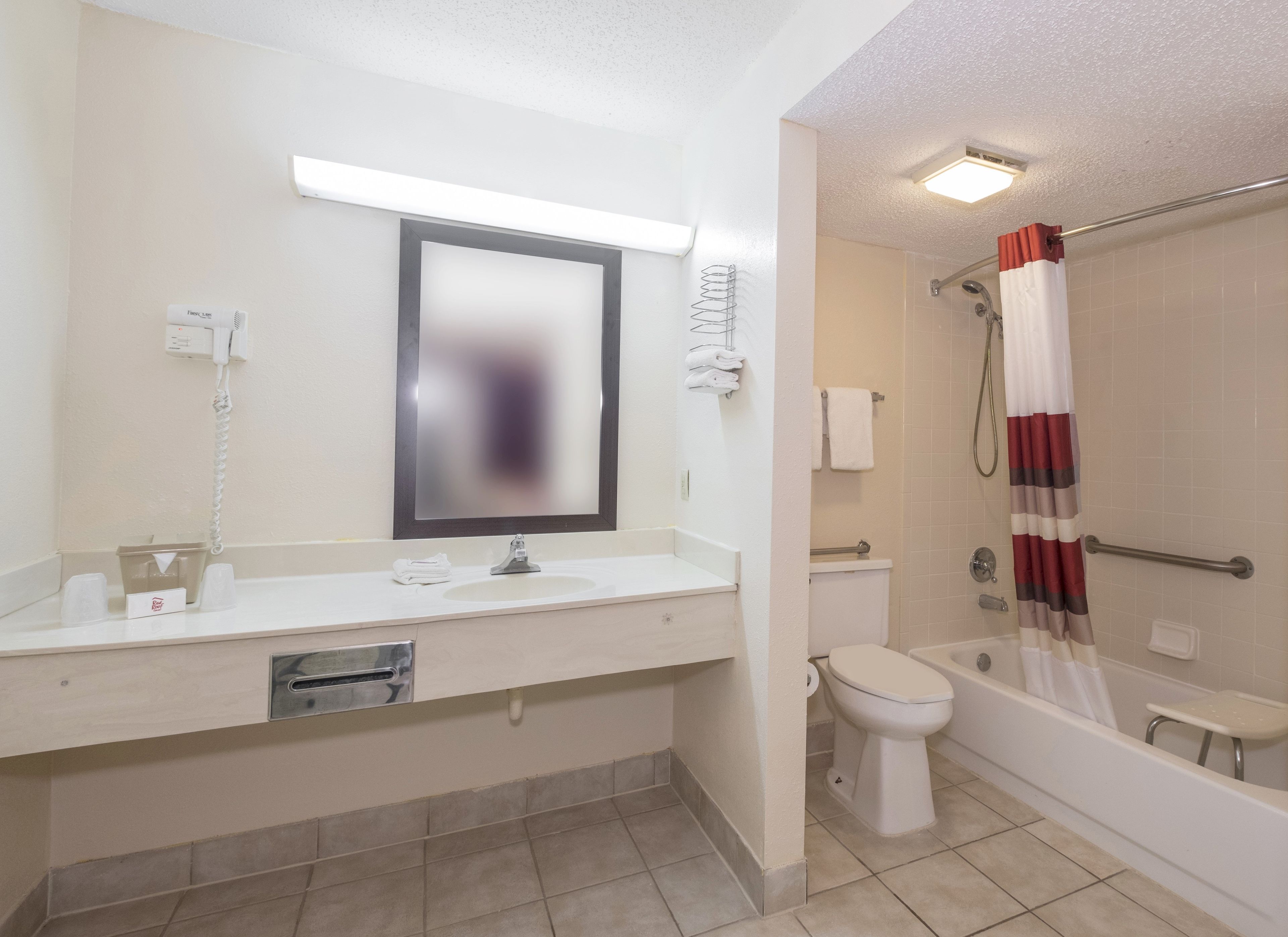 A bathroom with a sink, toilet, and bathtub.