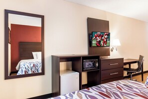 A hotel room with a bed, a desk with a chair, a television, a microwave, and a mirror. - Red Roof Inn Acworth - Emerson/ LakePoint South (Acworth)