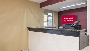 A reception desk with a sign indicating free Wi-Fi in all rooms. - Red Roof Inn Acworth - Emerson/ LakePoint South (Acworth)