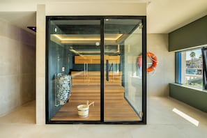 A modern interior with a glass door leading to a wooden staircase and a view of the outside.