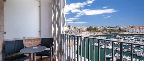 A balcony with a view of a marina and buildings.