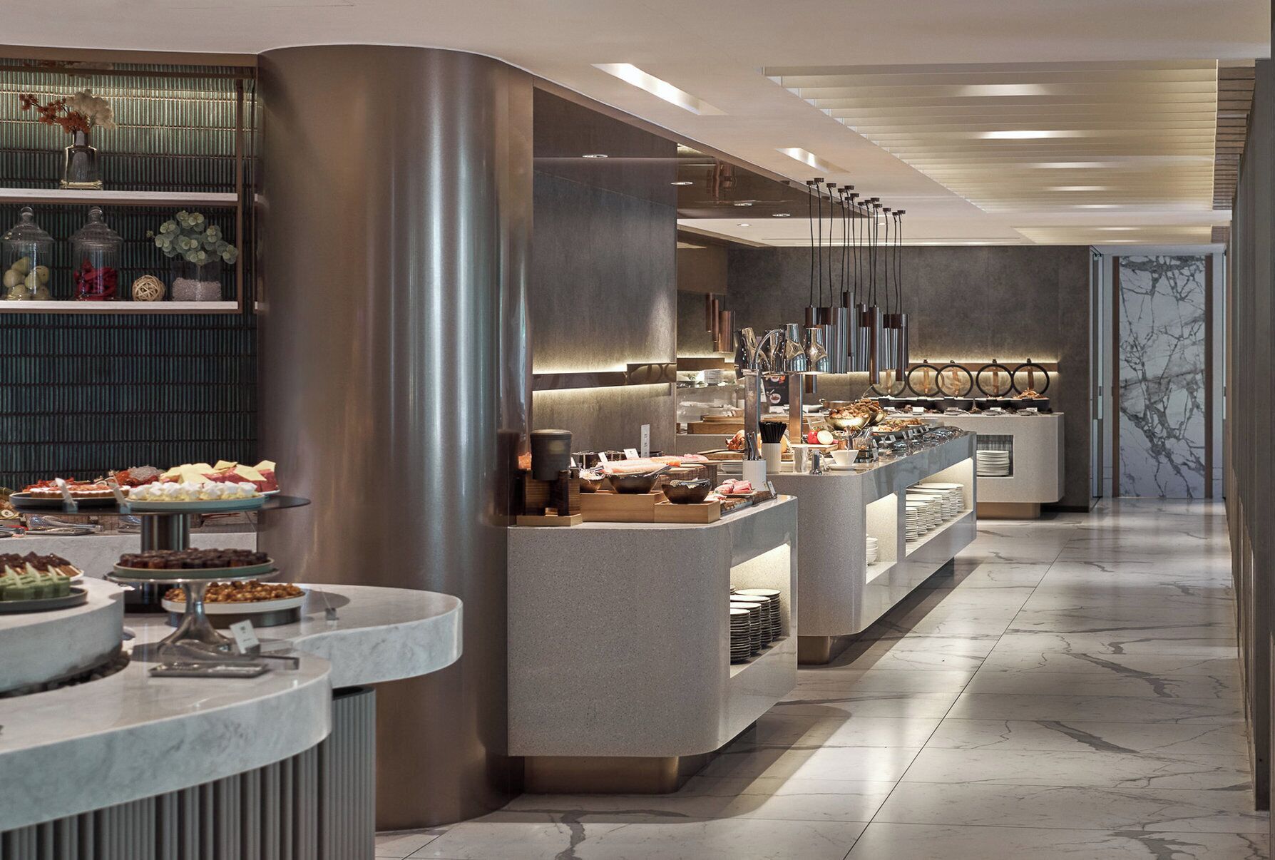 A modern buffet setup with various food items and a marble floor.