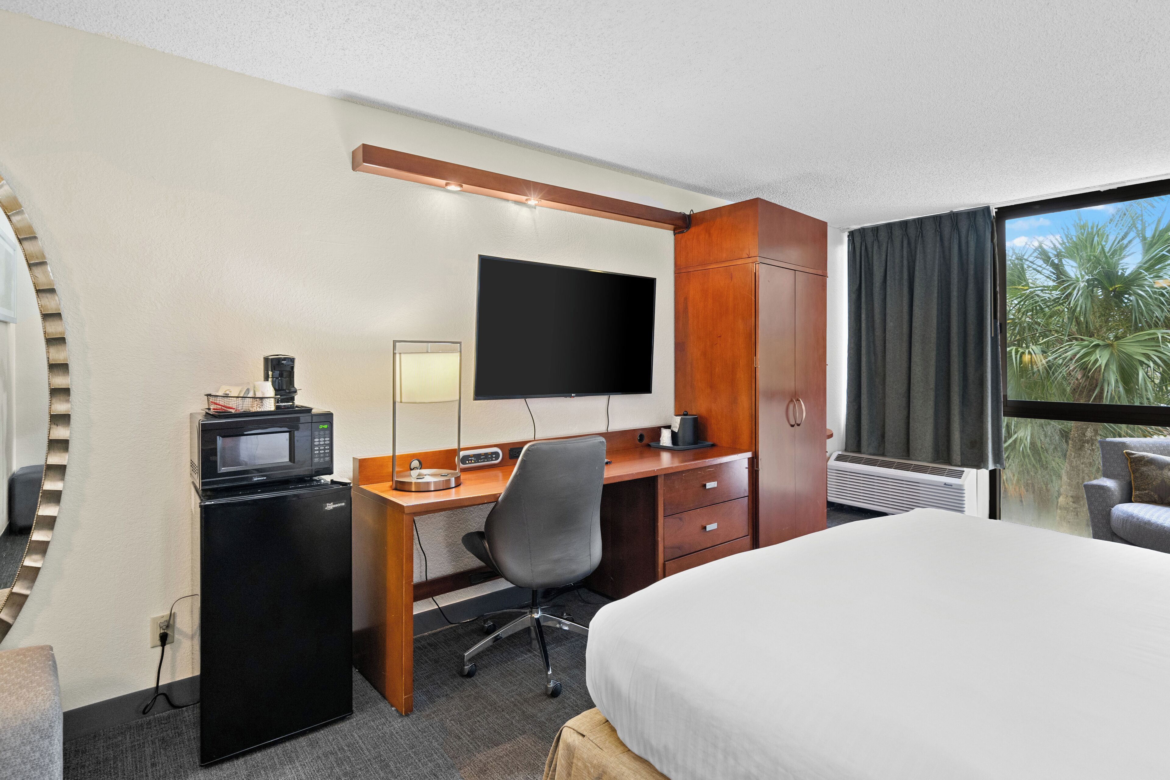 deluxe room, 1 king bed, non smoking, pool view | in-room safe, soundproofing, iron/ironing board, free wifi