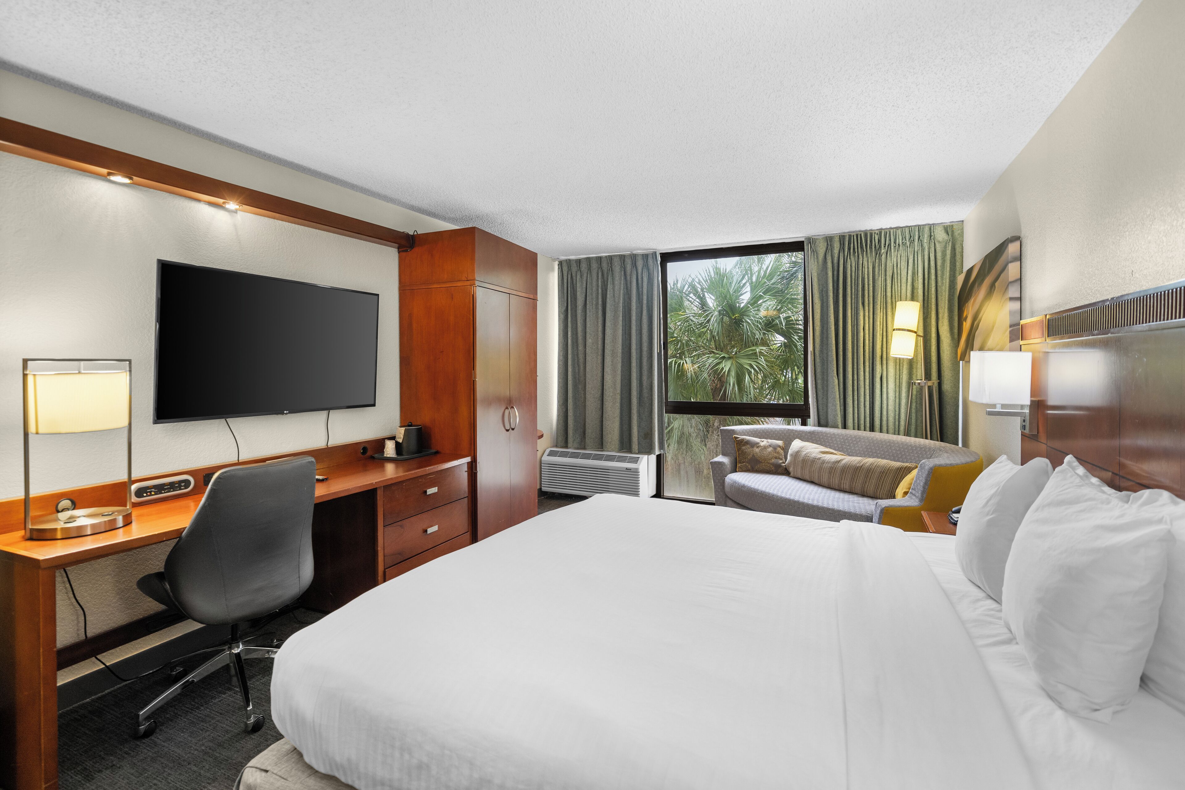 deluxe room, 1 king bed, non smoking, pool view | in-room safe, soundproofing, iron/ironing board, free wifi