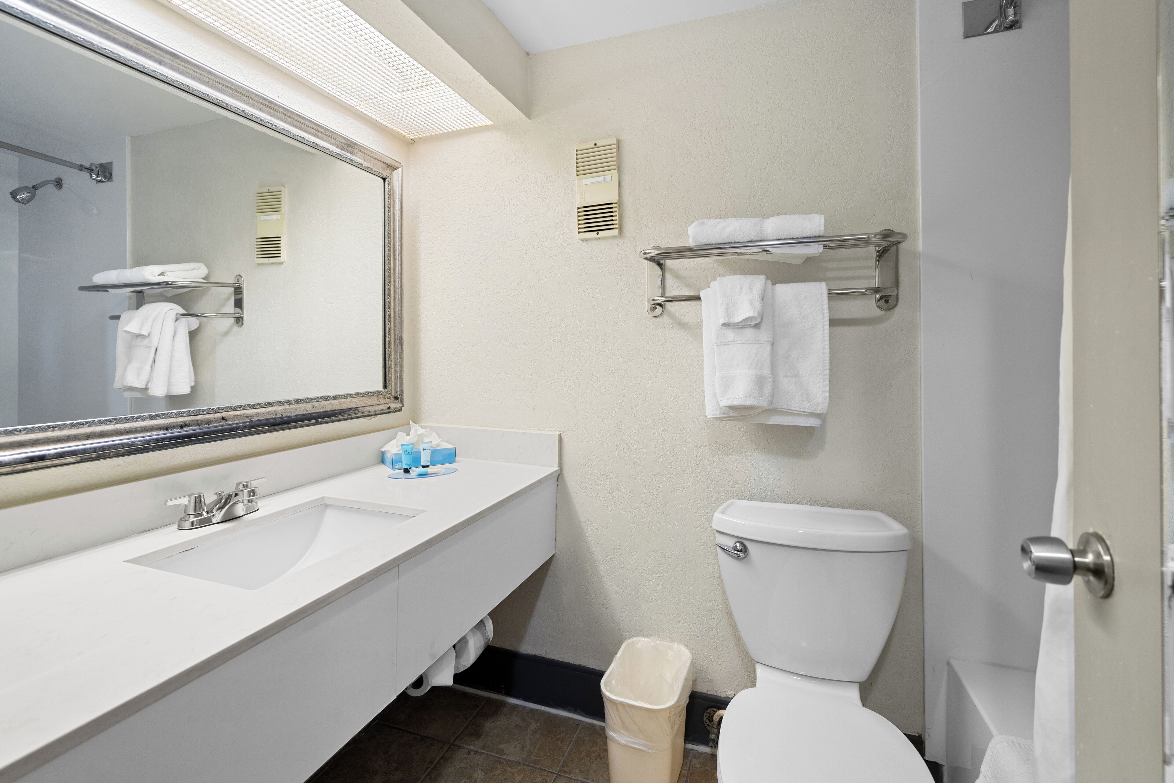 separate bathtub and shower, rainfall showerhead, hair dryer, towels