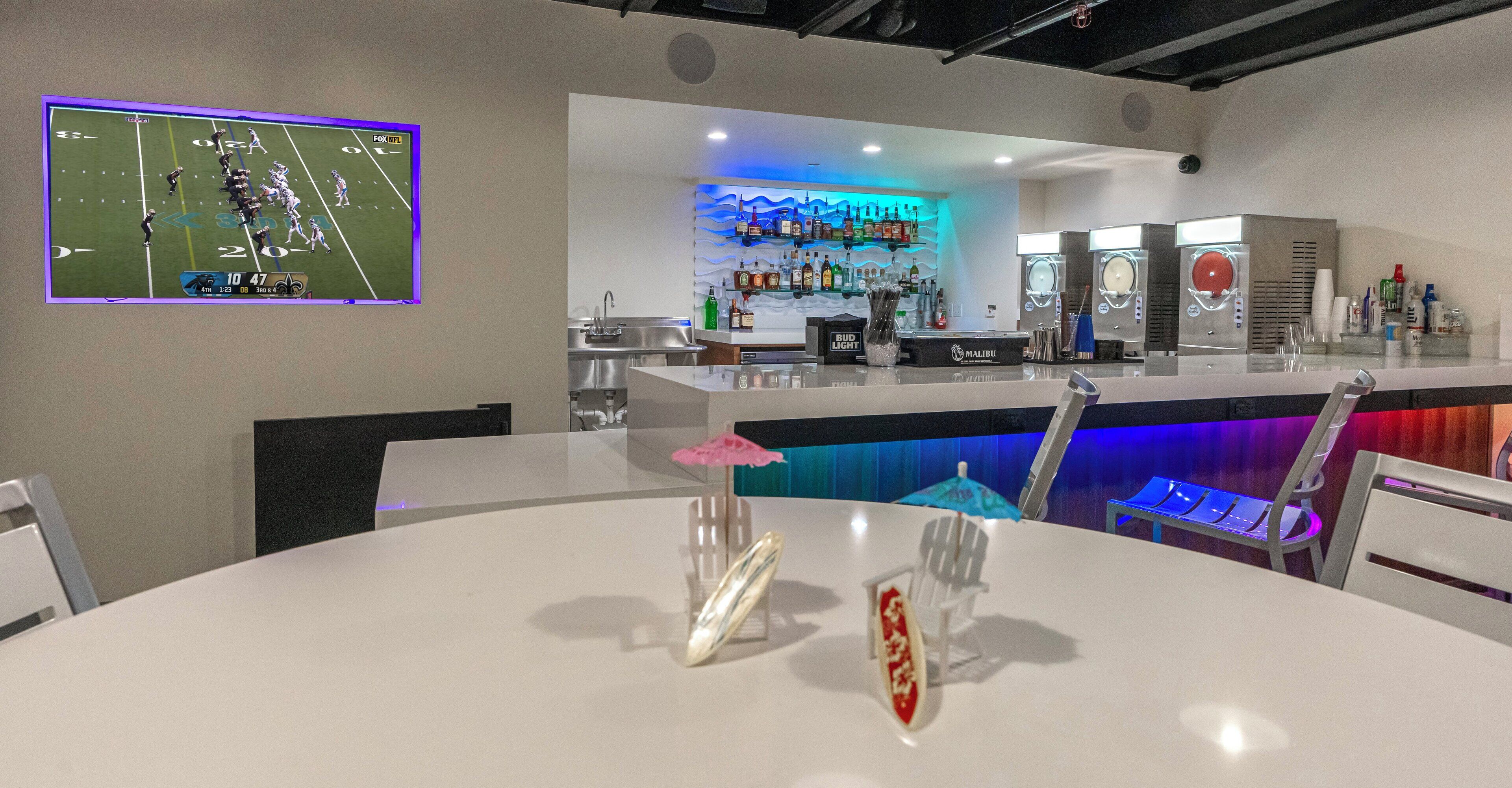 A bar area with a counter, bar stools, and a seating area with tables and chairs.
