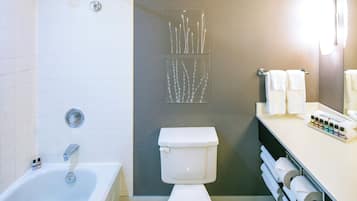 A bathroom with a bathtub, toilet, and towel rack.
