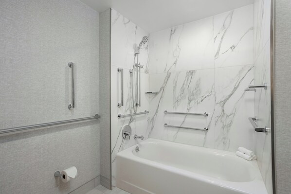 A modern bathroom with a bathtub, a shower, and a toilet. - Loews Nashville Hotel at Vanderbilt Plaza (Nashville)
