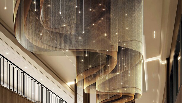 A spacious lobby with a high ceiling, a central staircase, and a modern design.