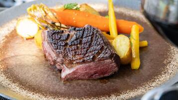 A steak with vegetables on a plate.
